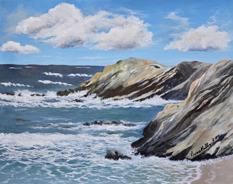 A rocky headland of pale striped stone running out into turquoise sea under a bright cloudy sky