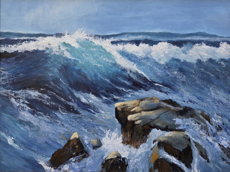 A turquoise wave curling and breaking over dark rocks in open sea